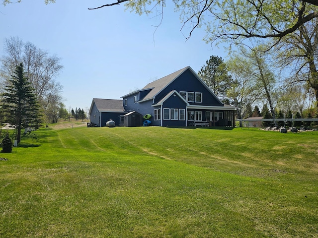 back of property with a lawn