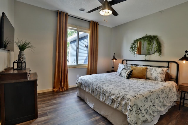 bedroom with dark wood-type flooring, baseboards, and ceiling fan