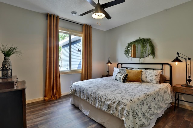 bedroom with dark wood-style flooring, baseboards, and a ceiling fan