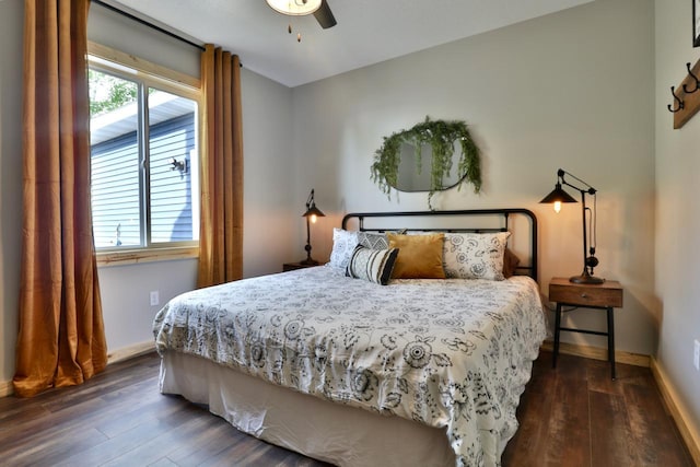 bedroom featuring dark wood-style flooring, baseboards, and a ceiling fan