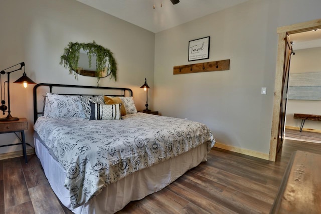 bedroom with wood finished floors and baseboards