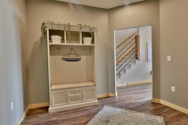 mudroom with dark wood-style floors and baseboards