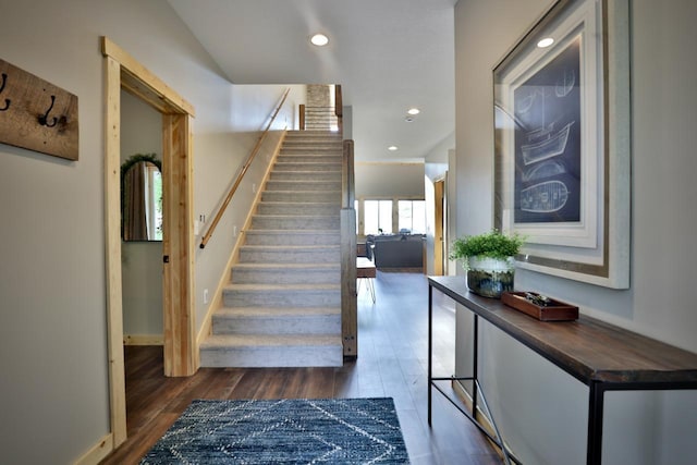 stairway featuring wood finished floors, recessed lighting, and baseboards