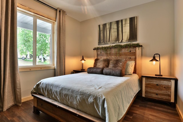 bedroom featuring wood finished floors and baseboards