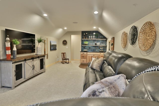 living room featuring vaulted ceiling, light colored carpet, a bar, recessed lighting, and baseboards