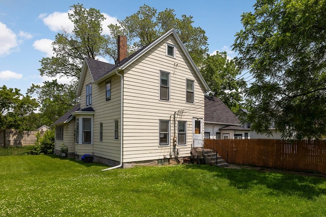 1102 Pacific St, Saint Paul, MN 55106 - rear view of house featuring a chimney and a shingled roof
