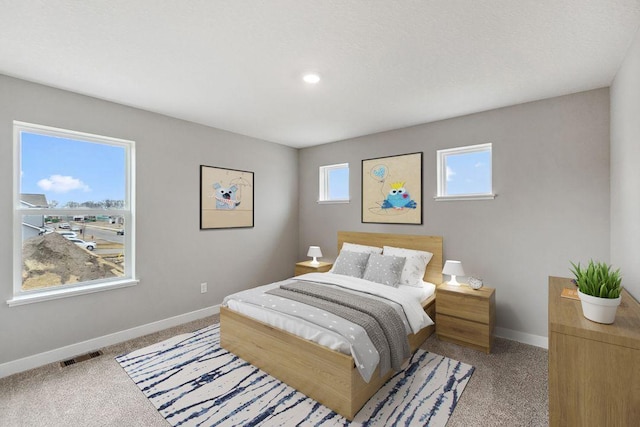 bedroom featuring recessed lighting, baseboards, visible vents, and light colored carpet