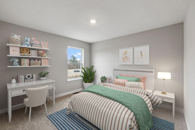 carpeted bedroom featuring baseboards and a textured ceiling