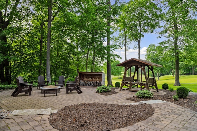 5610 Burl Oaks Ct, Minnetrista, MN 55364 - view of patio / terrace with an outdoor fire pit, a gazebo, and view of wooded area