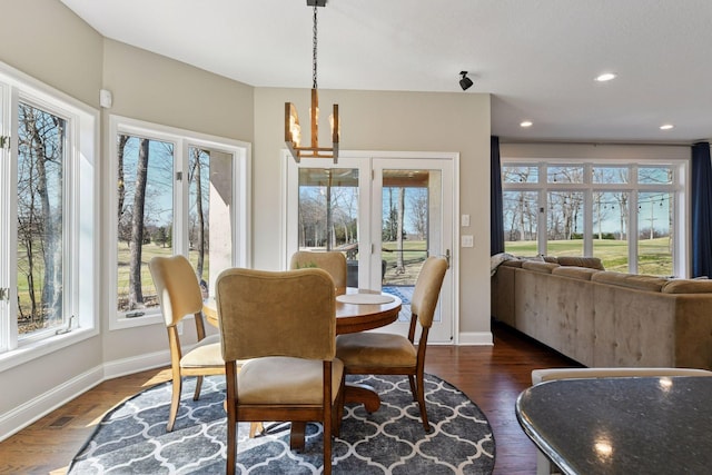 5610 Burl Oaks Ct, Minnetrista, MN 55364 - dining area with baseboards, a chandelier, dark wood-type flooring, and recessed lighting