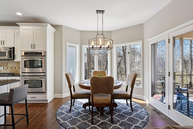 5610 Burl Oaks Ct, Minnetrista, MN 55364 - dining room featuring a chandelier, recessed lighting, dark wood-type flooring, and baseboards