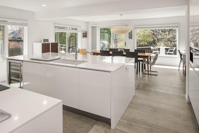 3710 Vincent Ave S, Minneapolis, MN 55410 - kitchen with a sink, wine cooler, white cabinets, light countertops, and modern cabinets