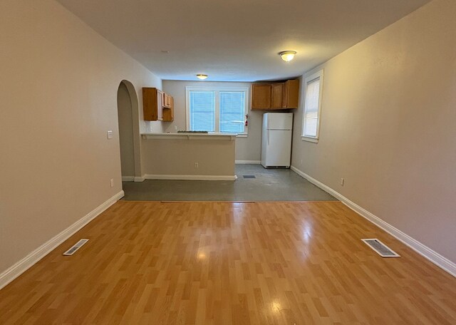 529 Blair Ave, Saint Paul, MN 55103 - unfurnished living room featuring light wood-style flooring and arched walkways