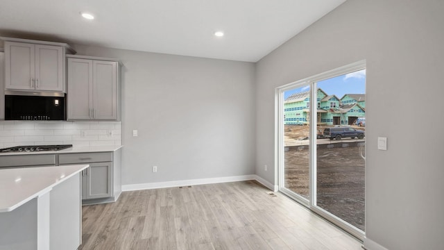 kitchen featuring light wood-style floors and gray cabinets