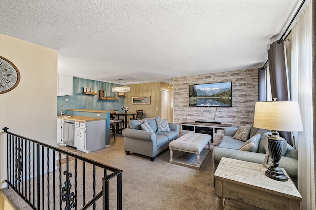 living area featuring wooden walls, a textured ceiling, and light colored carpet