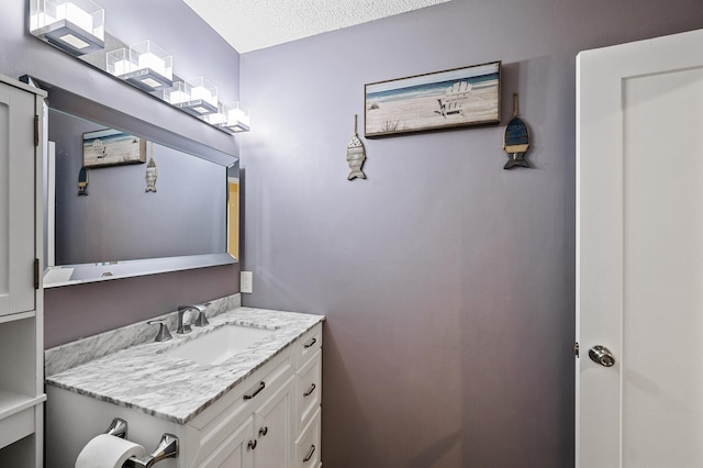 bathroom featuring vanity and a textured ceiling