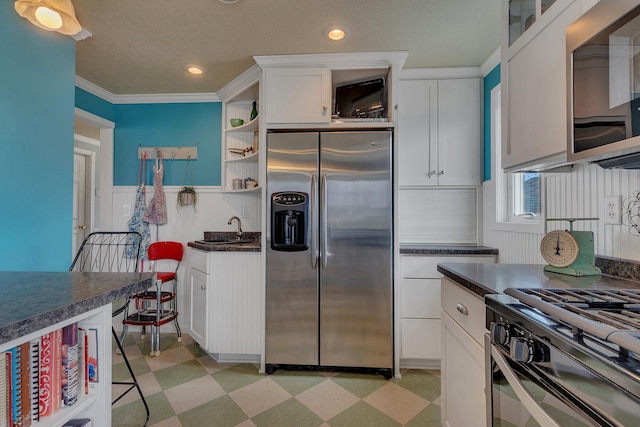 1205 Melvina Rd SW, Alexandria, MN 56308 - kitchen with white cabinets, dark countertops, appliances with stainless steel finishes, and light floors