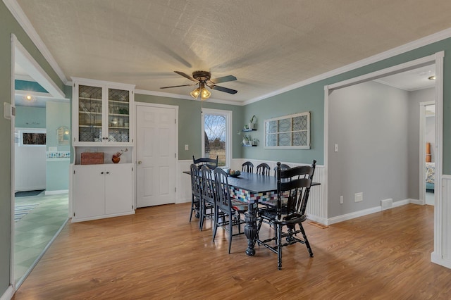 1205 Melvina Rd SW, Alexandria, MN 56308 - dining room with ceiling fan, ornamental molding, and light wood finished floors