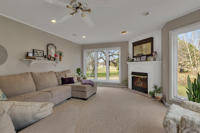 1205 Melvina Rd SW, Alexandria, MN 56308 - carpeted living room with ceiling fan, a glass covered fireplace, and a wealth of natural light