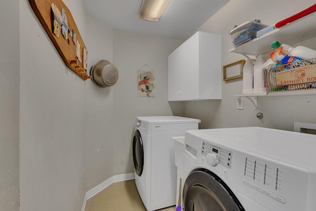 1205 Melvina Rd SW, Alexandria, MN 56308 - clothes washing area with baseboards, cabinet space, and washer and clothes dryer