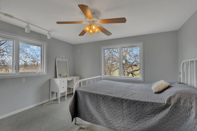 1205 Melvina Rd SW, Alexandria, MN 56308 - carpeted bedroom featuring track lighting, baseboards, and a ceiling fan
