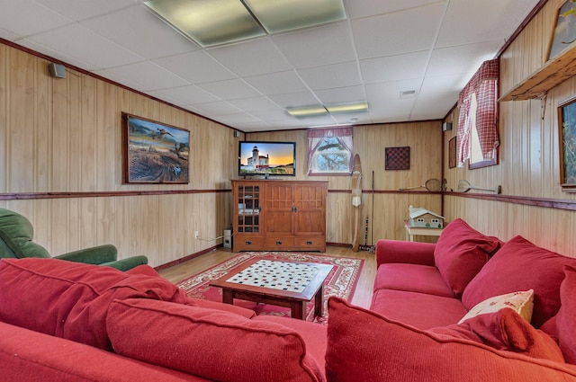 1205 Melvina Rd SW, Alexandria, MN 56308 - living area with baseboards, wood walls, a drop ceiling, and light wood-style flooring