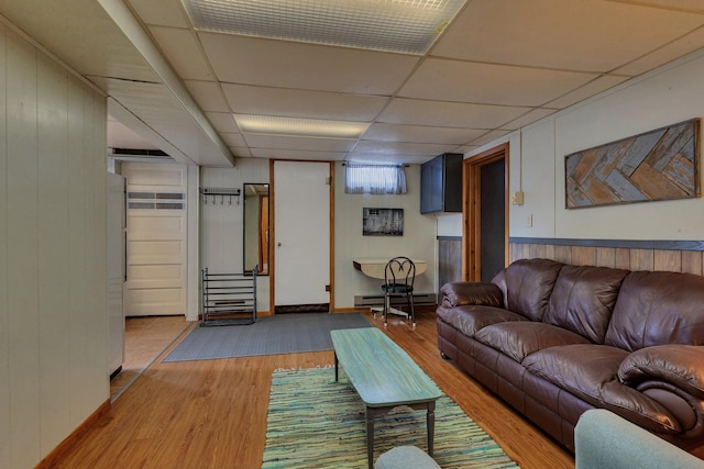 1205 Melvina Rd SW, Alexandria, MN 56308 - living area featuring wooden walls, wood finished floors, baseboard heating, and a paneled ceiling
