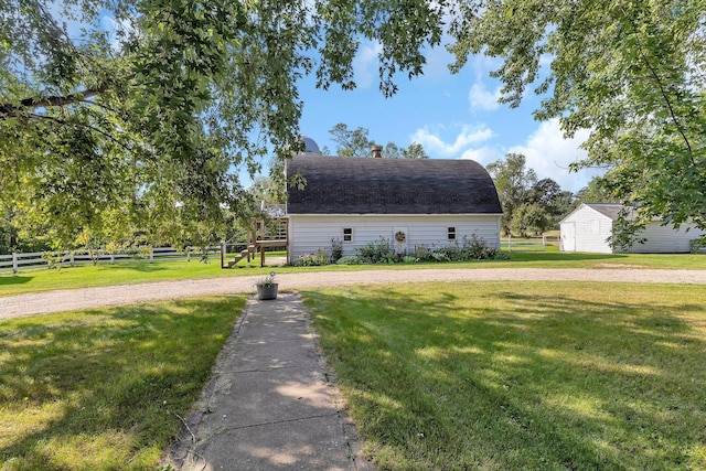 1205 Melvina Rd SW, Alexandria, MN 56308 - view of side of home with a lawn, fence, and an outbuilding