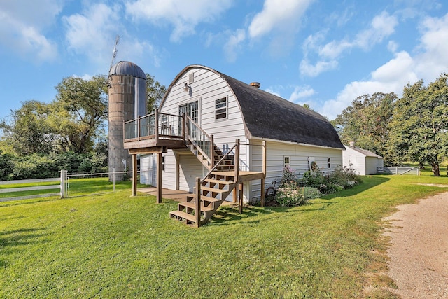 1205 Melvina Rd SW, Alexandria, MN 56308 - back of property with a wooden deck, fence, stairs, and a lawn