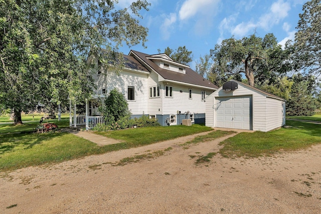 1205 Melvina Rd SW, Alexandria, MN 56308 - back of house featuring a garage, an outbuilding, a lawn, driveway, and metal roof