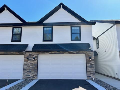 3405 Douglas Dr N, Crystal, MN 55422 - view of front of home featuring an attached garage and stone siding