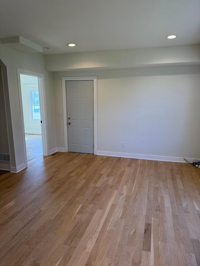 436 Adams St SE, Hutchinson, MN 55350 - unfurnished room with baseboards, recessed lighting, and wood finished floors