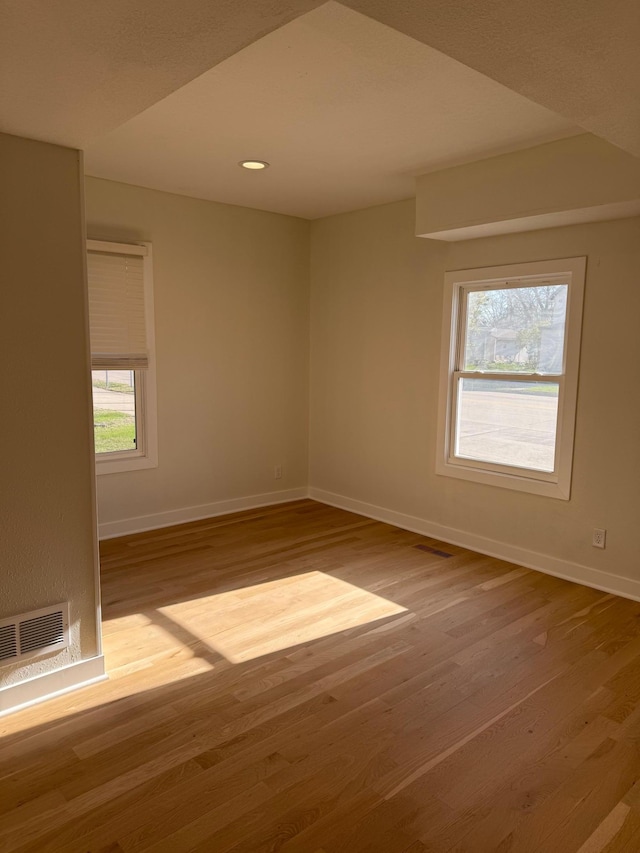 436 Adams St SE, Hutchinson, MN 55350 - empty room with baseboards, visible vents, and wood finished floors