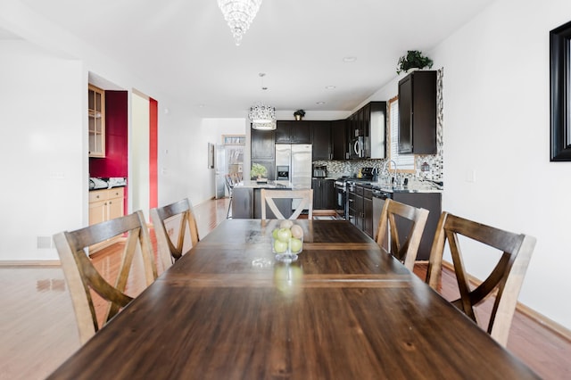 dining room with a notable chandelier and wood finished floors