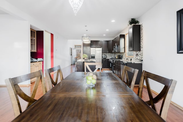 dining room featuring a chandelier, wood finished floors, and recessed lighting