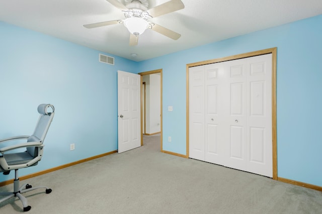 unfurnished office with baseboards, carpet flooring, and visible vents