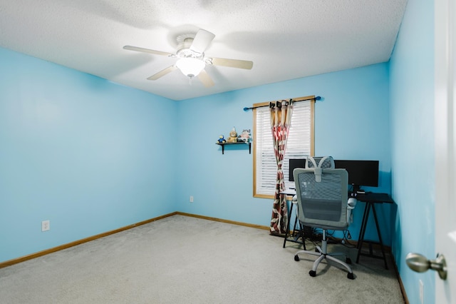 carpeted home office featuring ceiling fan, baseboards, and a textured ceiling