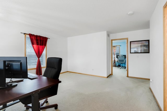 carpeted office with a textured ceiling, visible vents, and baseboards