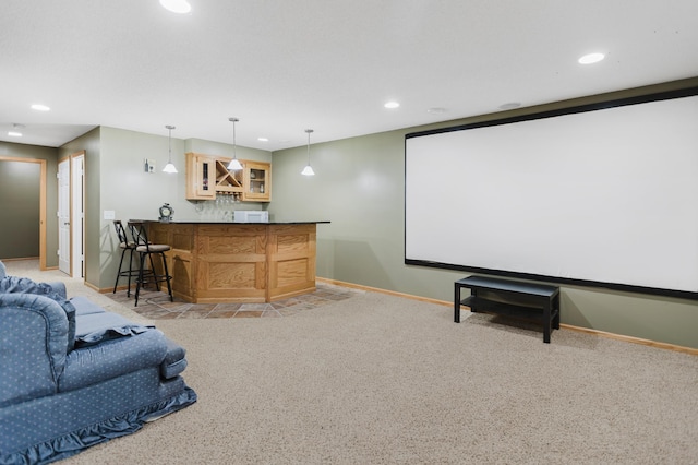 cinema room featuring recessed lighting, wet bar, baseboards, and light colored carpet