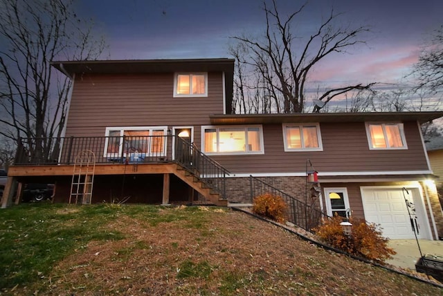 1164 Hawthorn St, Red Wing, MN 55066 - rear view of house featuring stairs, an attached garage, a deck, and a lawn