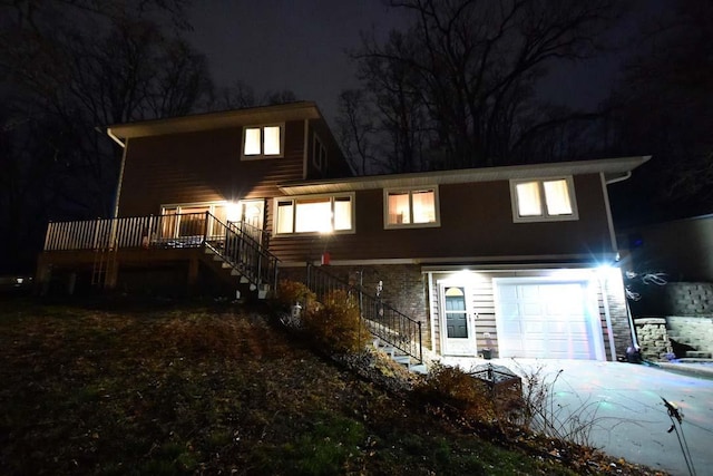 1164 Hawthorn St, Red Wing, MN 55066 - view of front of home with stairs, a garage, a deck, and driveway