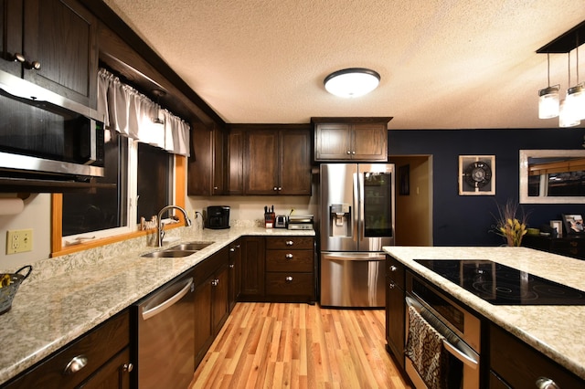 1164 Hawthorn St, Red Wing, MN 55066 - kitchen featuring stainless steel appliances, a sink, a textured ceiling, dark brown cabinets, and light wood-style flooring