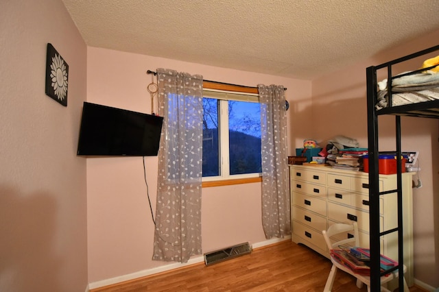 1164 Hawthorn St, Red Wing, MN 55066 - bedroom with wood finished floors, a textured ceiling, and baseboards