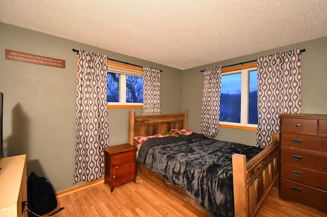 1164 Hawthorn St, Red Wing, MN 55066 - bedroom with light wood finished floors, a textured ceiling, and baseboards