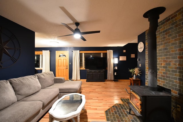 1164 Hawthorn St, Red Wing, MN 55066 - living area with a wood stove, a ceiling fan, and light wood-type flooring