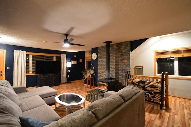 1164 Hawthorn St, Red Wing, MN 55066 - living room with a wood stove, wood finished floors, ceiling fan, and a textured ceiling
