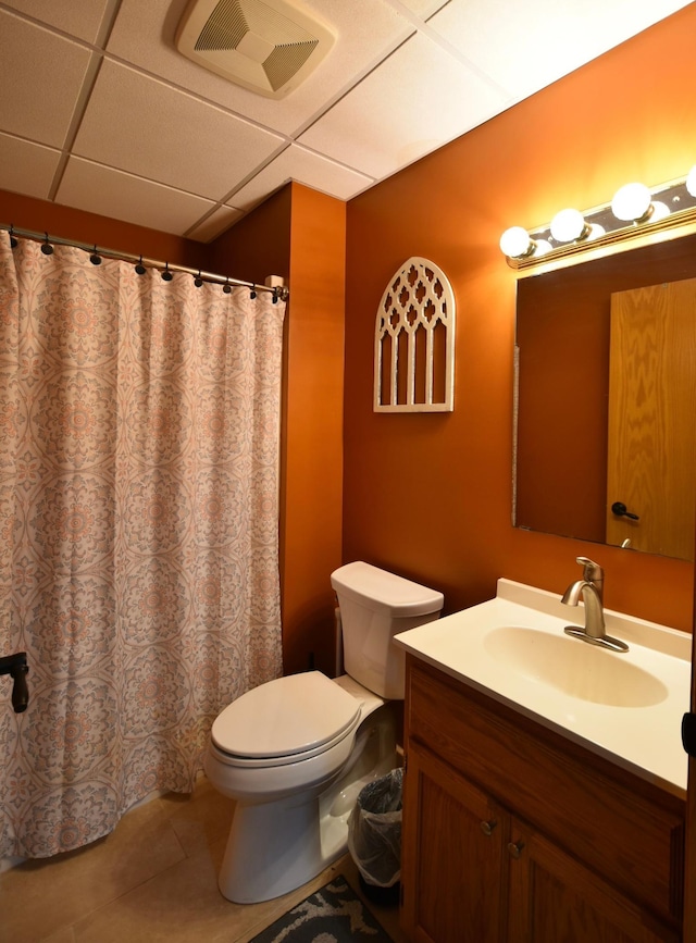 1164 Hawthorn St, Red Wing, MN 55066 - bathroom with toilet, vanity, a paneled ceiling, tile patterned flooring, and curtained shower