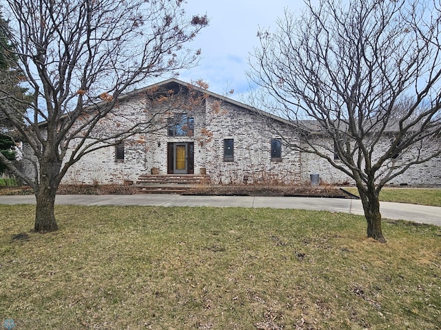 3127 Peterson Pkwy N, Fargo, ND 58102 - view of front of property with a front yard, brick siding, and curved driveway
