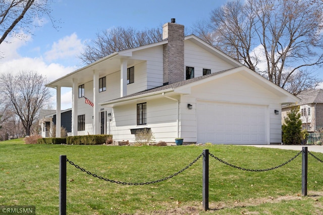 exterior space with a chimney, an attached garage, driveway, and a front lawn