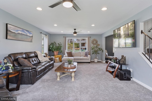carpeted living area featuring baseboards, a ceiling fan, recessed lighting, and stairs